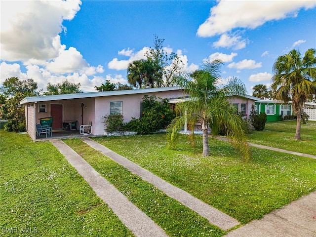 view of front of property featuring a carport and a front lawn