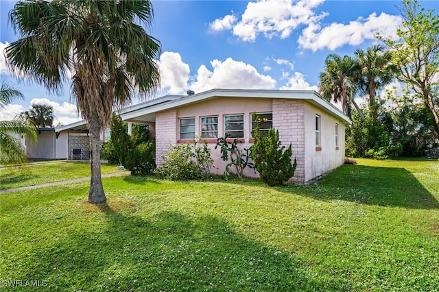 view of home's exterior with a yard