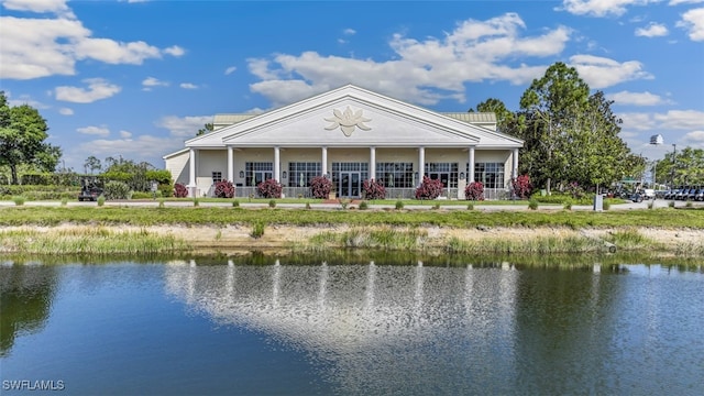 back of property featuring a water view