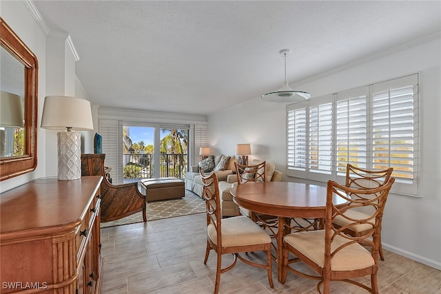 dining area featuring a textured ceiling and crown molding