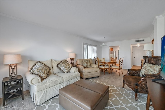 living room featuring ornamental molding and light hardwood / wood-style floors