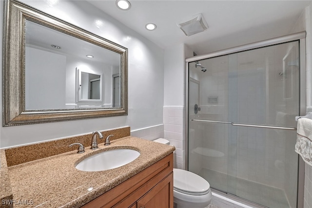 bathroom featuring walk in shower, vanity, and toilet