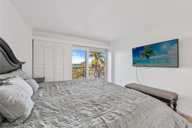 bedroom with hardwood / wood-style flooring and access to exterior