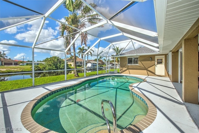 view of swimming pool featuring glass enclosure, a water view, and a patio