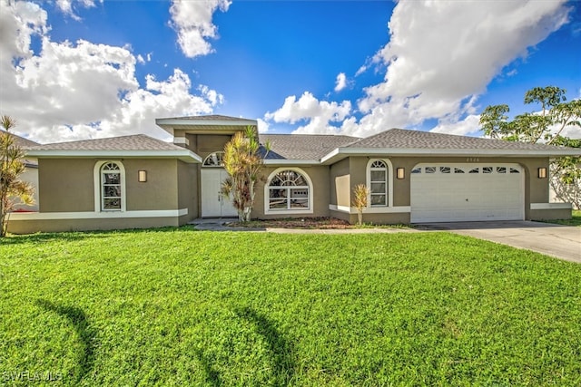 view of front of property with a front yard and a garage