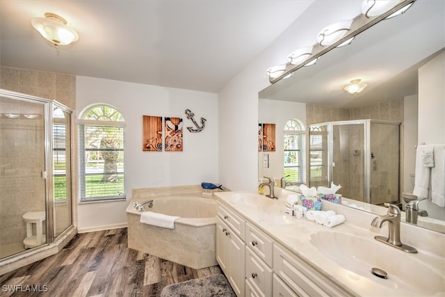 bathroom with shower with separate bathtub, a healthy amount of sunlight, lofted ceiling, and hardwood / wood-style flooring