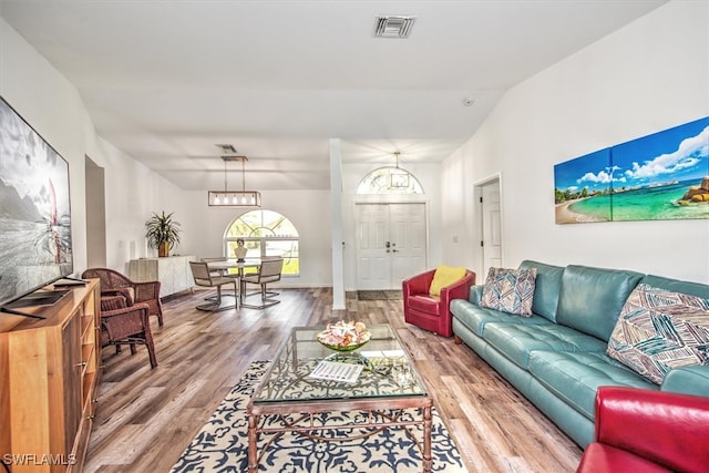 living room with hardwood / wood-style floors and vaulted ceiling