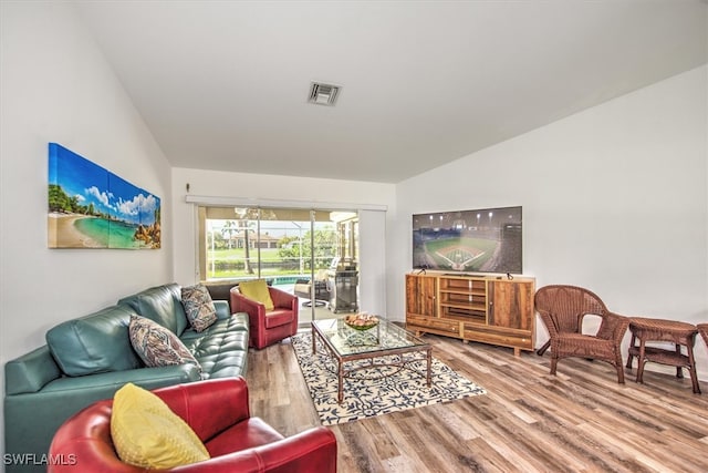 living room featuring hardwood / wood-style flooring and lofted ceiling