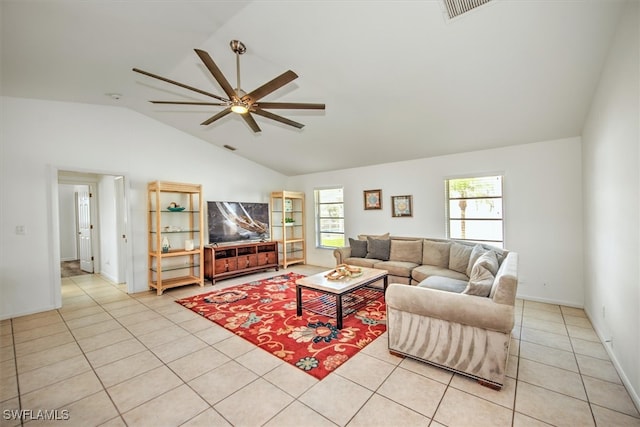 living room featuring ceiling fan, light tile patterned floors, and vaulted ceiling