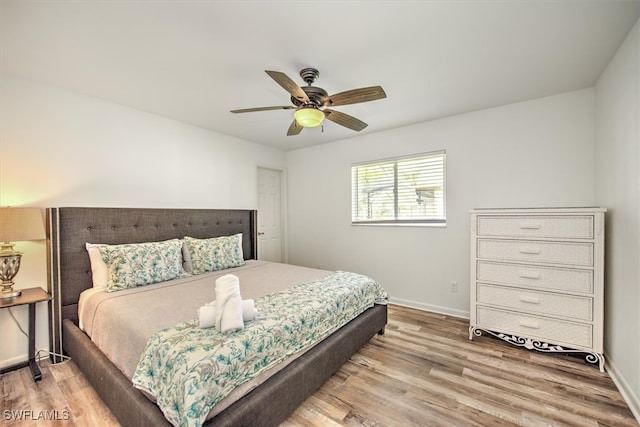 bedroom with hardwood / wood-style flooring and ceiling fan