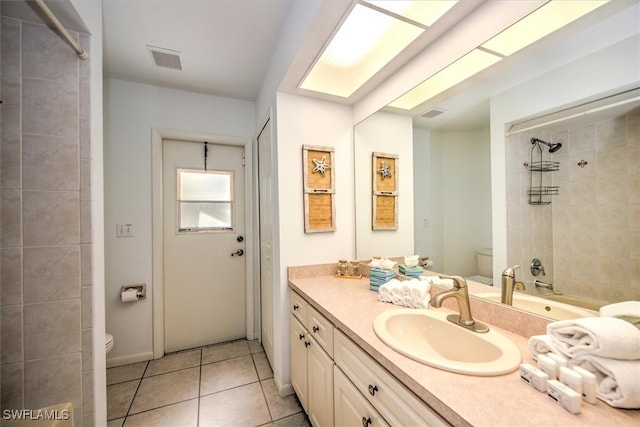 bathroom with tile patterned flooring, vanity, and toilet