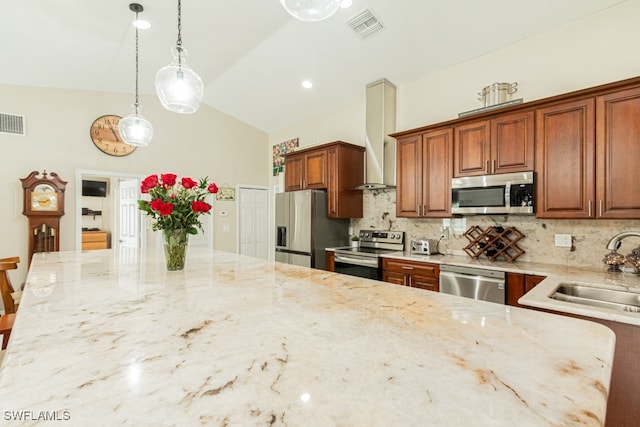 kitchen with sink, decorative backsplash, light stone countertops, appliances with stainless steel finishes, and decorative light fixtures