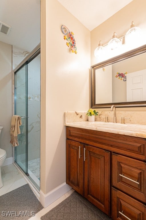 bathroom featuring vanity, toilet, and walk in shower