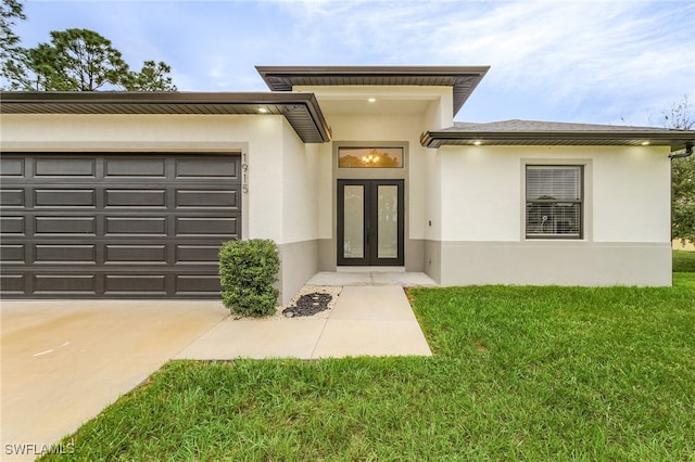 property entrance featuring a garage and a lawn