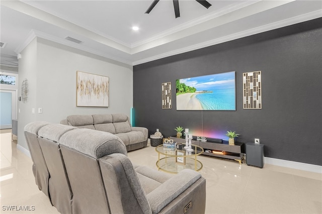 cinema room with ceiling fan, light tile patterned floors, and ornamental molding