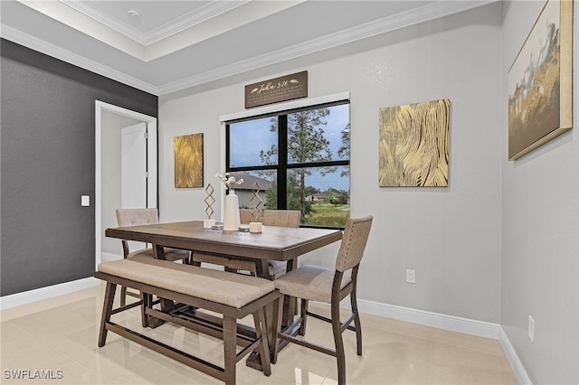 dining space featuring light tile patterned floors and crown molding