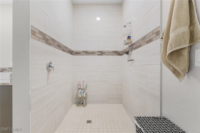 bathroom with tiled shower