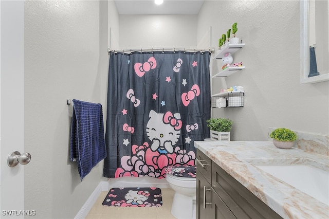 bathroom with vanity, tile patterned flooring, and toilet