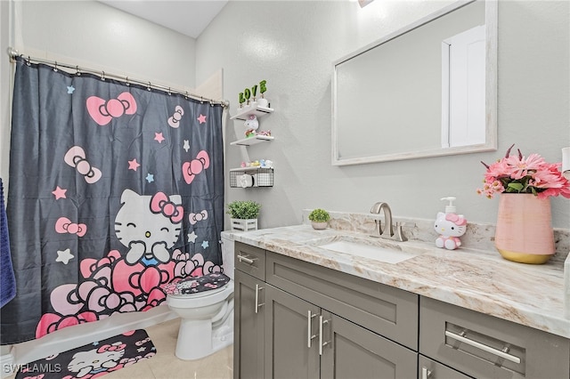 full bathroom with tile patterned flooring, vanity, shower / bath combo with shower curtain, and toilet