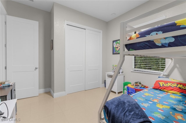 bedroom featuring light tile patterned floors and a closet