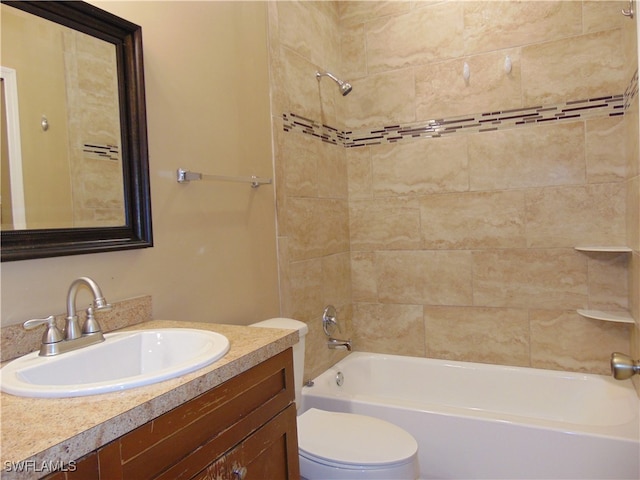 full bathroom featuring vanity, toilet, and tiled shower / bath combo