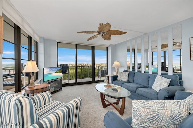 carpeted living room with expansive windows, plenty of natural light, and ceiling fan