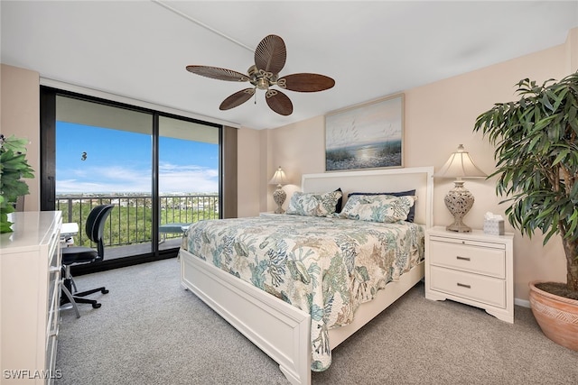 carpeted bedroom featuring access to outside, ceiling fan, and floor to ceiling windows