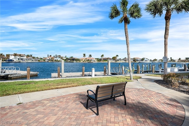 view of community with a dock and a water view