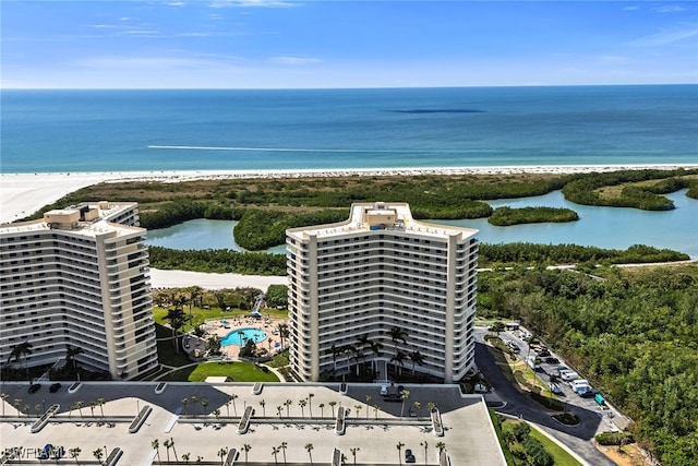 drone / aerial view with a water view and a beach view