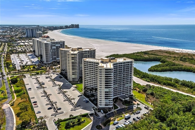 birds eye view of property with a view of the beach and a water view