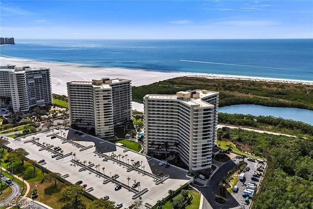 drone / aerial view with a beach view and a water view