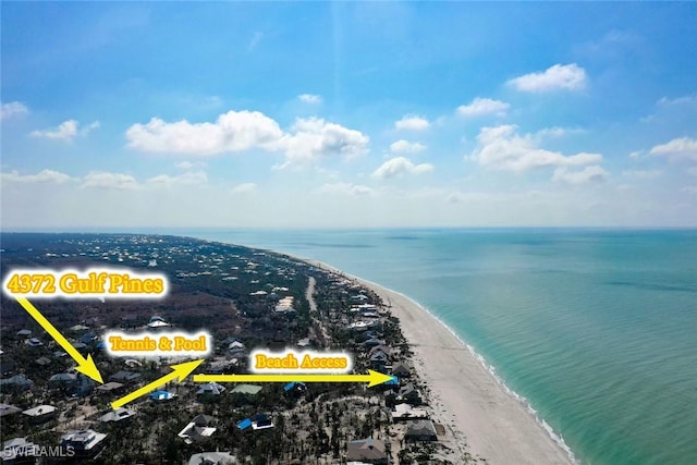 birds eye view of property with a water view and a view of the beach