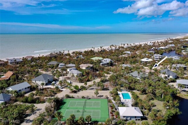 drone / aerial view with a water view and a beach view