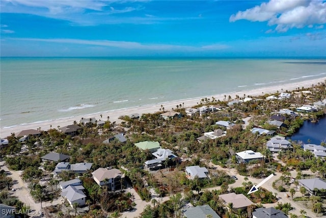 drone / aerial view with a beach view and a water view