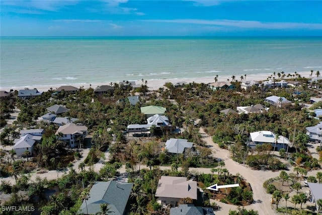 aerial view with a water view and a beach view