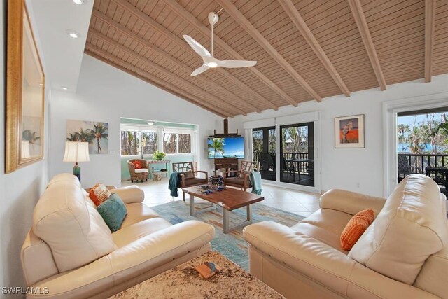 tiled living room featuring ceiling fan, wood ceiling, plenty of natural light, and high vaulted ceiling