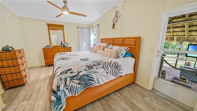 bedroom with ceiling fan, vaulted ceiling, and light wood-type flooring