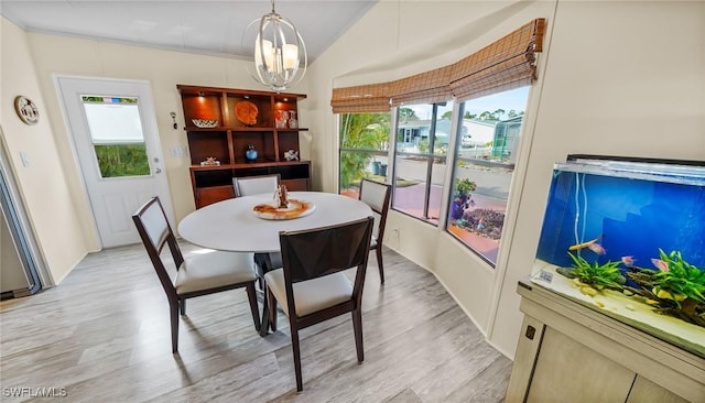 dining area with a notable chandelier and light hardwood / wood-style floors