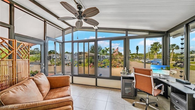 sunroom with ceiling fan and lofted ceiling