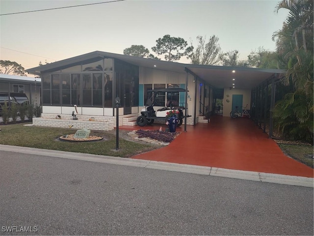 manufactured / mobile home featuring a sunroom and a carport