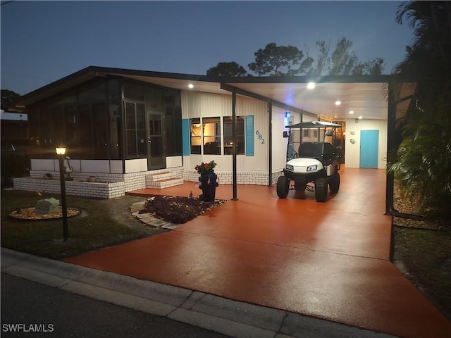 manufactured / mobile home with a carport and a sunroom