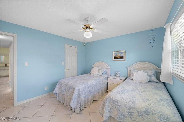 bedroom with a textured ceiling, light tile patterned floors, and ceiling fan