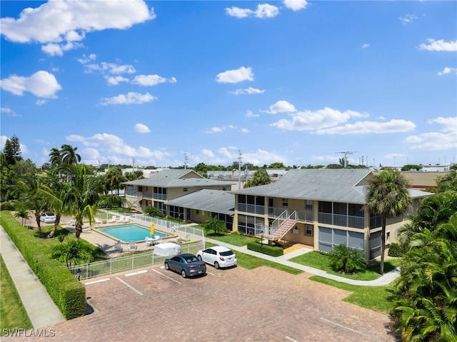 view of swimming pool with a sunroom and a patio area