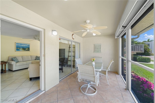 sunroom featuring ceiling fan