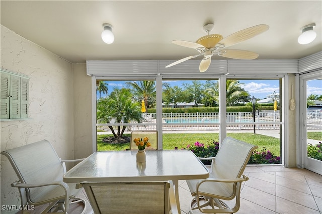 sunroom featuring ceiling fan