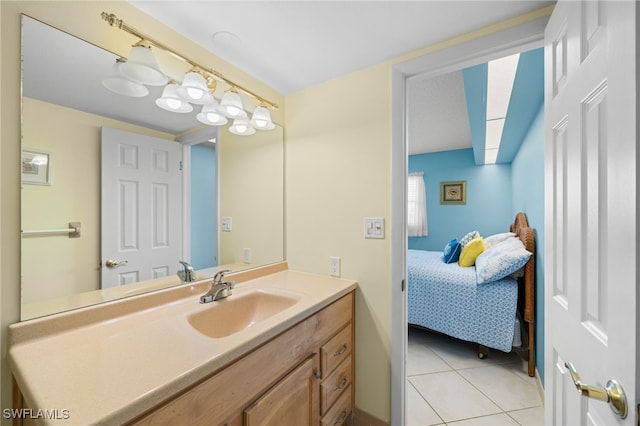 bathroom with a skylight, vanity, and tile patterned flooring