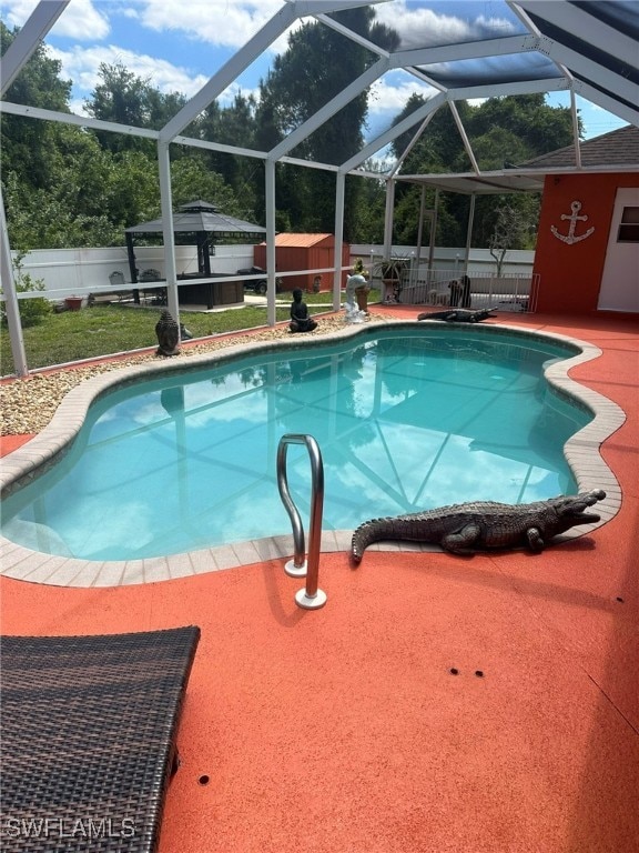 view of swimming pool featuring glass enclosure and a patio area