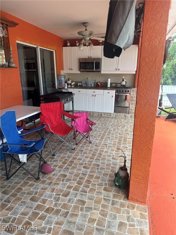 view of patio / terrace with an outdoor kitchen and ceiling fan