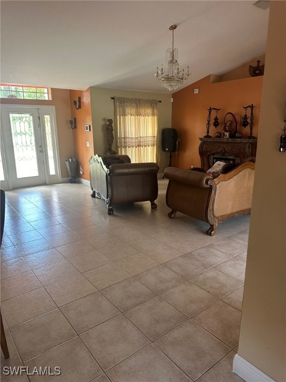 living room with light tile patterned flooring, an inviting chandelier, and vaulted ceiling