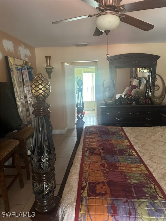 tiled bedroom with ceiling fan